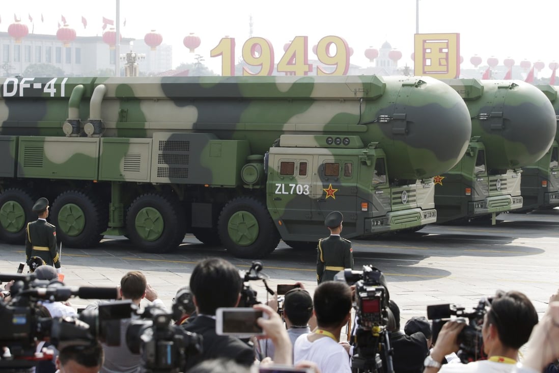Military vehicles carrying intercontinental ballistic missiles drive past Tiananmen Square in Beijing during a celebratory parade. Photo: Reuters