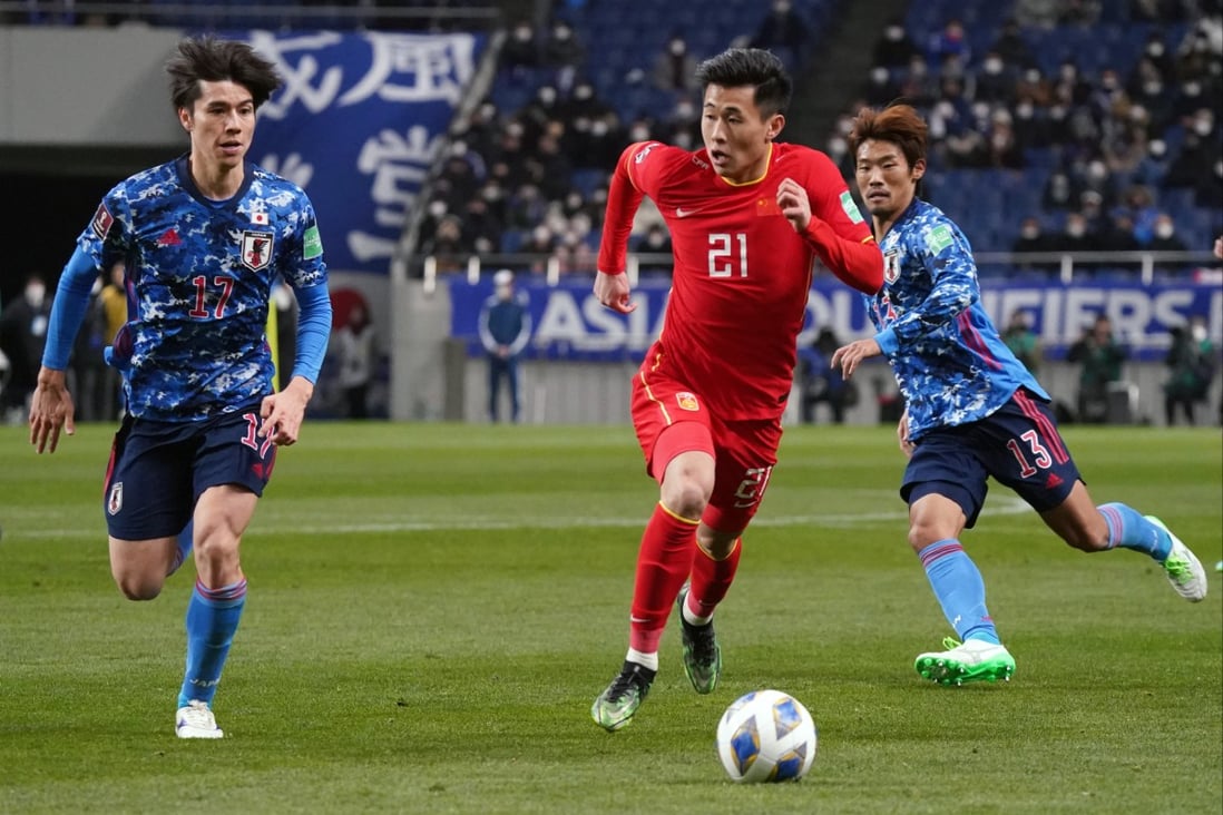 Dai Weijun of China controls the ball under pressure of Ao Tanaka of Japan during the FIFA World Cup Asian Qualifier Final Round Group B match between Japan and China at Saitama Stadium on January 27, 2022. Photo: Getty