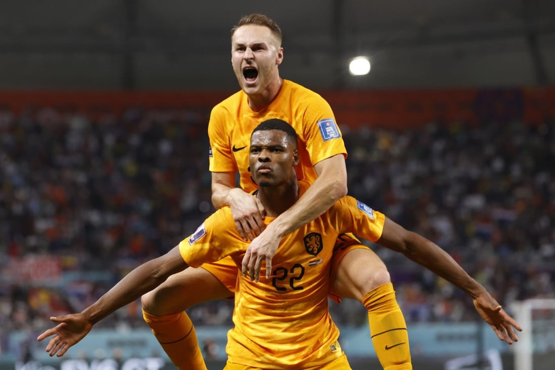Denzel Dumfries of the Netherlands celebrates with teammate Teun Koopmeiners, top, at the Fifa World Cup match against the US in Doha, Qatar on Saturday. Photo: EPA-EFE