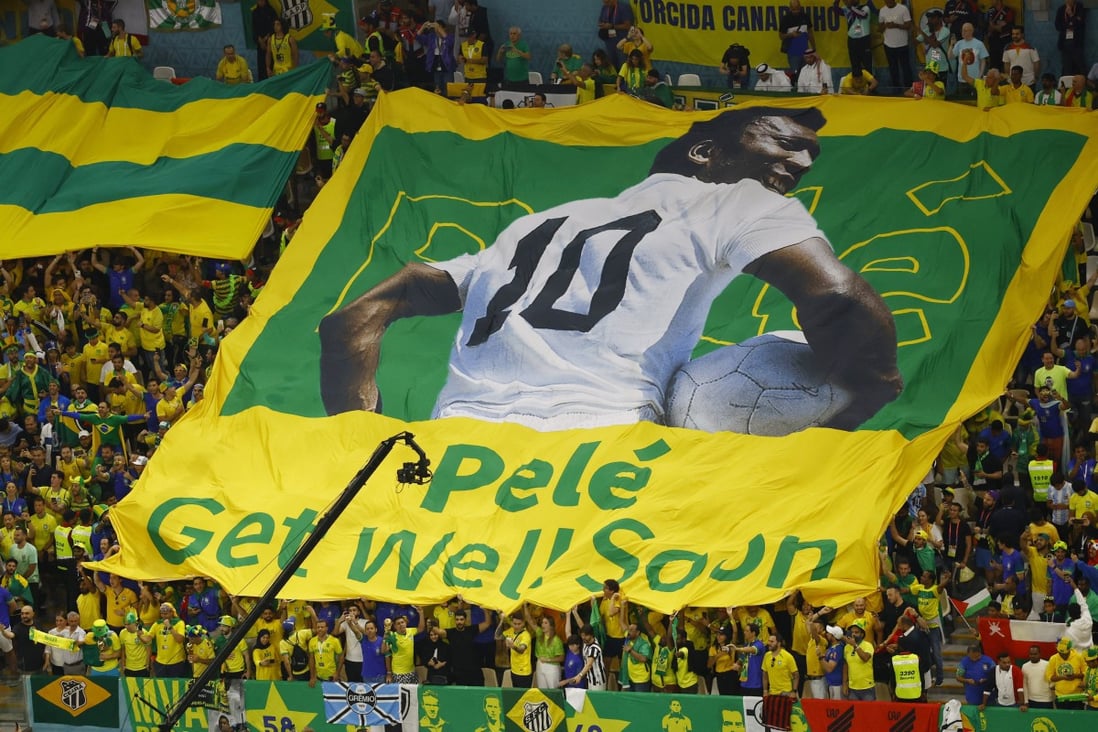 Brazil fans display a banner with an image of former football player Pele before their match on Friday. Photo: Reuters 