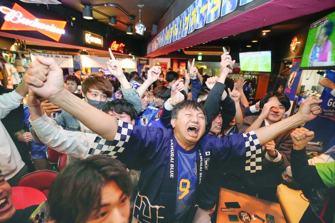 Fans at a bar in Tokyo celebrate Japan’s win over Spain at the World Cup. Photo: AP