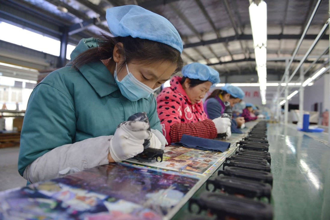 An employee works on an assembly line producing speakers at a factory in Fuyang, Anhui province, eastern China, on November 30. Global demand for Chinese products should drive economic recovery as China reopens, and there is also the prospect of greater lift from revived domestic consumer demand. Photo: AFP