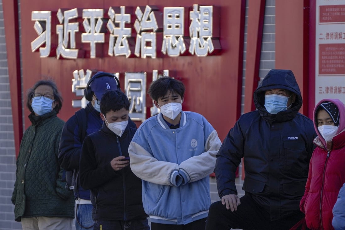 Residents wearing face masks wait in line for their routine Covid-19 tests in Beijing on Monday. Photo: AP Photo