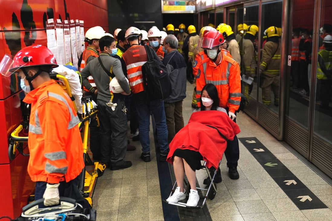 A woman is evacuated from Tseung Kwan O MTR station after a train stopped in the middle of the tracks. Photo: Elson Li