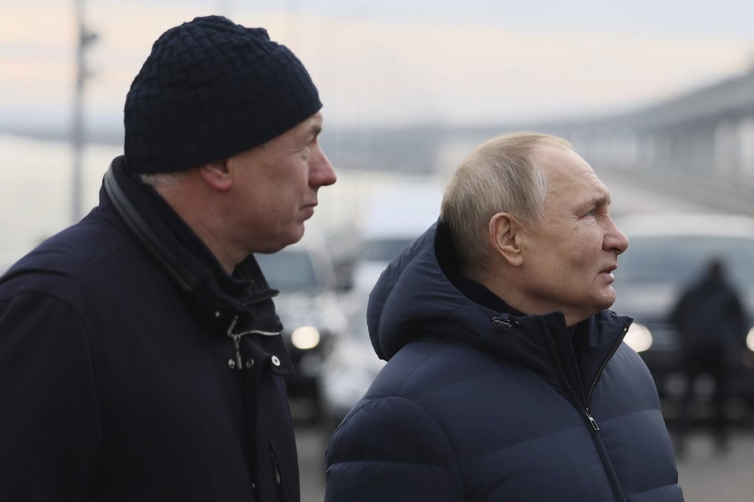 Russian President Vladimir Putin, right, and Deputy Prime Minister Marat Khusnullin visit the bridge connecting the Russian mainland and the occupied Crimean peninsula. The bridge was damaged by a truck bomb attack in October. Photo: Kremlin Pool via AP