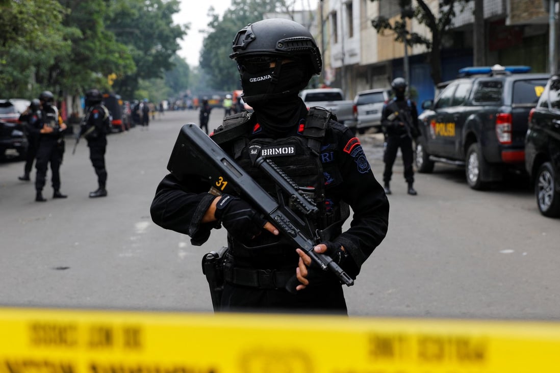 An armed police officer stands guard in Bandung, West Java province, following a blast at a district police station on Wednesday. Photo: Reuters
