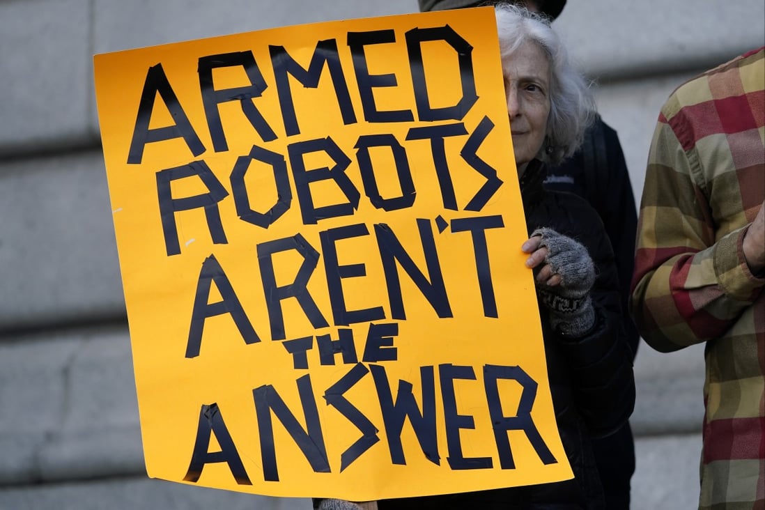 A protester in San Francisco holds up a sign while demonstrating on Monday against the use of “killer robots” by police. Photo: AP