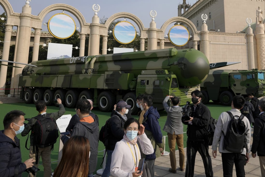 Visitors look at Chinese military vehicles carrying Dongfeng-41 and Dongfeng-17 ballistic missiles at the Beijing Exhibition Centre in October. Photo: AP