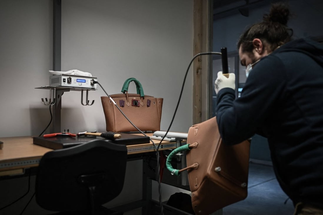 An employee working on a handbag at an Hermès leather goods workshop. The luxury goods manufacturer was the first to offer a restoration service. Photo: AFP