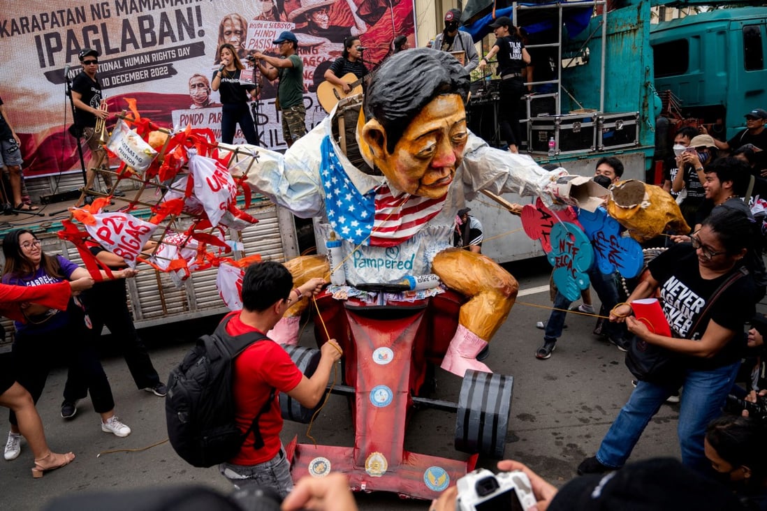 Filipino activists destroy an effigy depicting Philippine President Ferdinand Marcos Jr., during a protest in observance of Human Rights Day, in Manila, Philippines on Saturday. Photo: Reuters