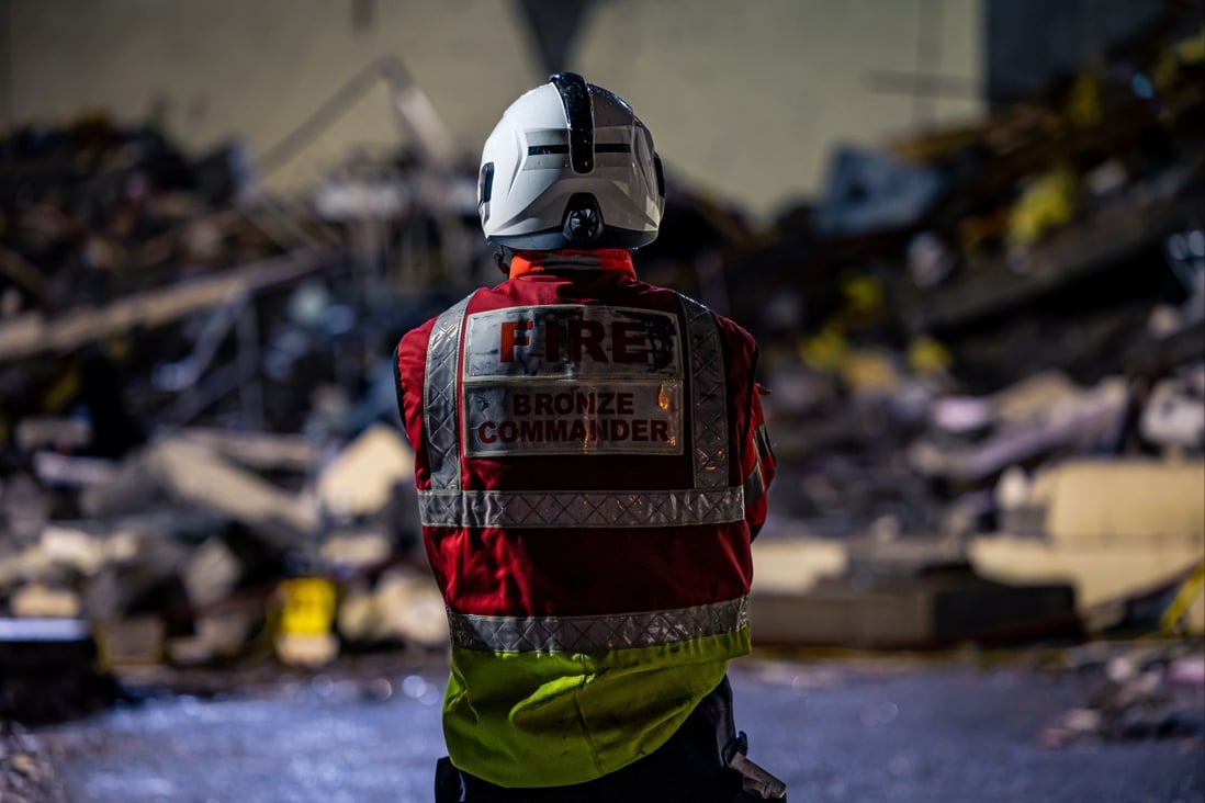 An emergency worker at the scene of an explosion and fire at a block of flats in St Helier, Jersey, Channel Islands on Sunday. Photo: Government of Jersey / EPA-EFE 