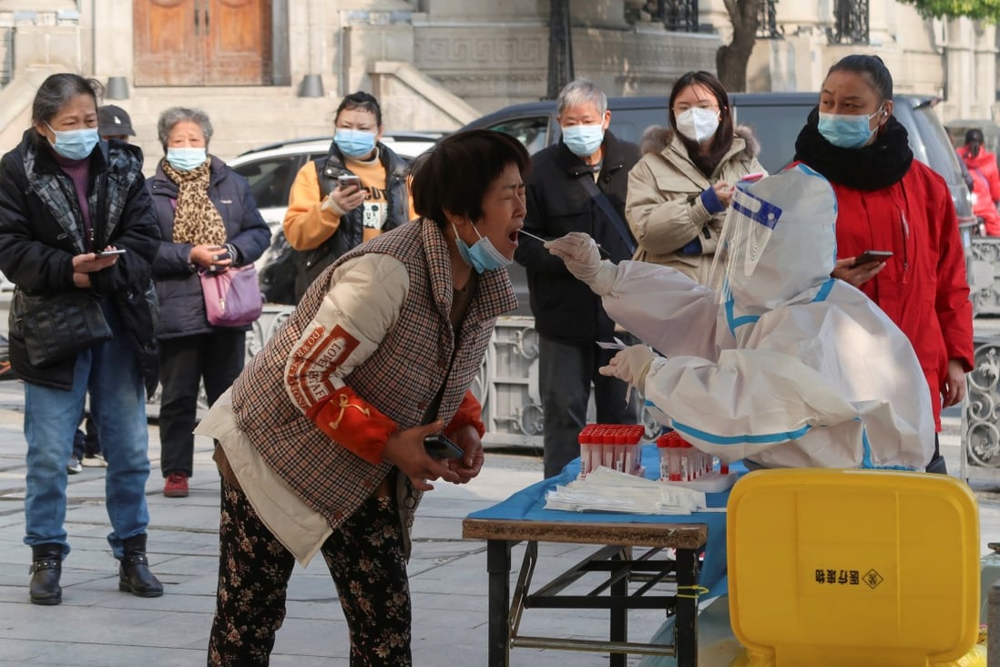 A medical worker takes a swab sample from a resident for testing, after the government eased rules for coronavirus disease control, in Wuhan, China, on December 10. Photo: Reuters