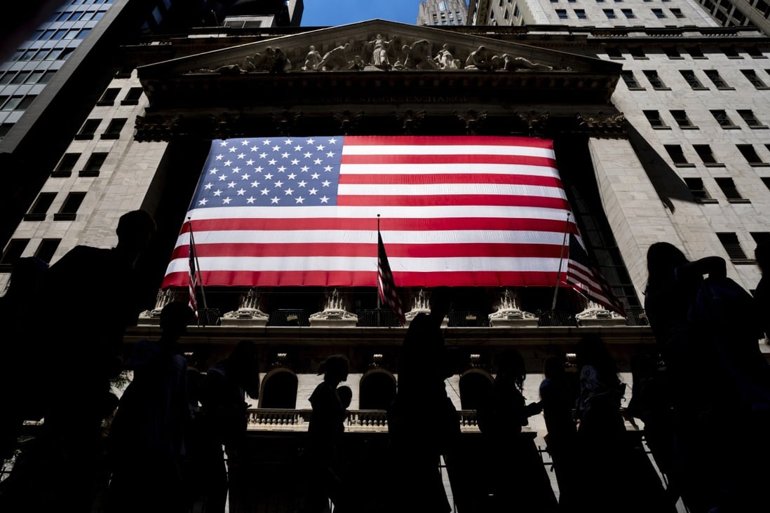 People walk past the New York Stock Exchange in June. Photo: AP