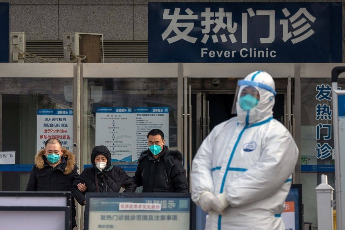 A worker in protective gear stands at the fever clinic at a hospital in Beijing on Wednesday. Photo: Bloomberg
