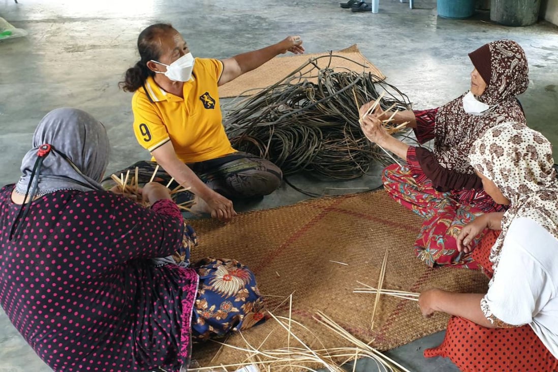 Sompong Ad-Inmong (second from left) teaches bamboo weaving to conflict-affected women in Pattani province. Photo: Handout
