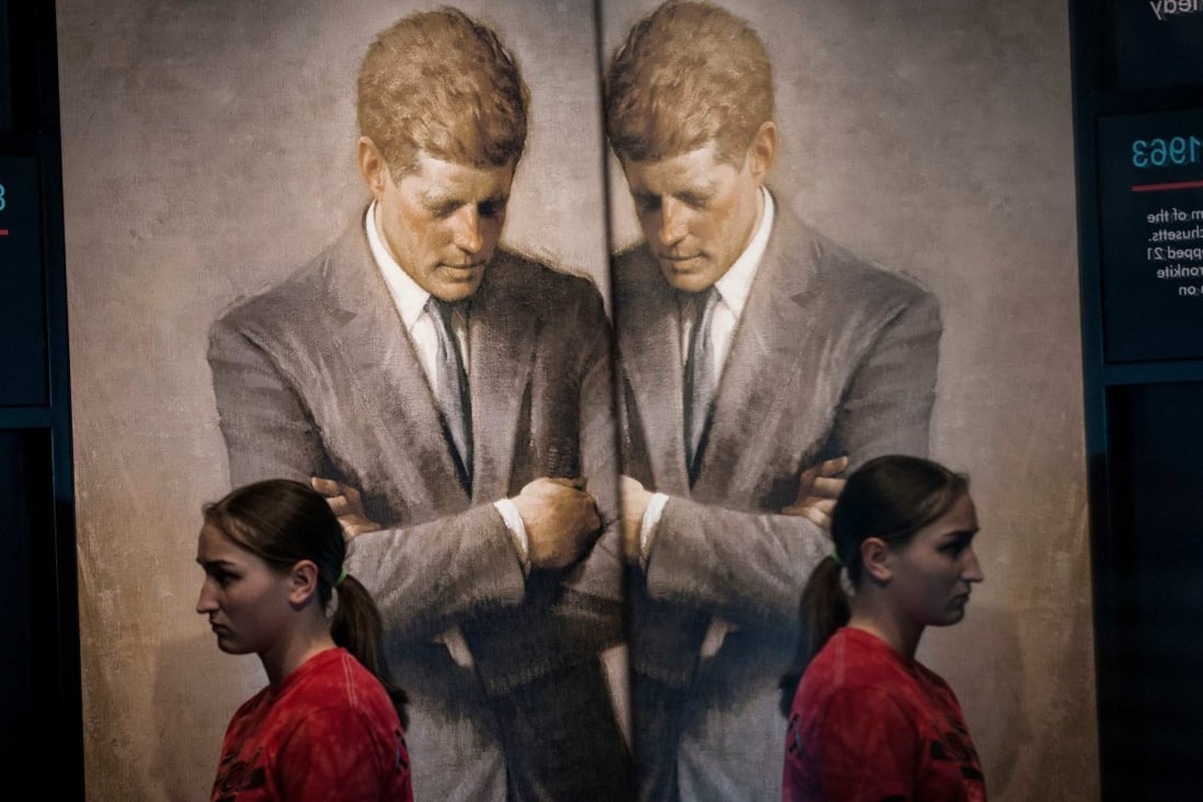 A student walks past a copy of Aaron Shikler’s official portrait of US President John F. Kennedy during an exhibit at the Newseum in Washington in April 2013. Photo: AFP