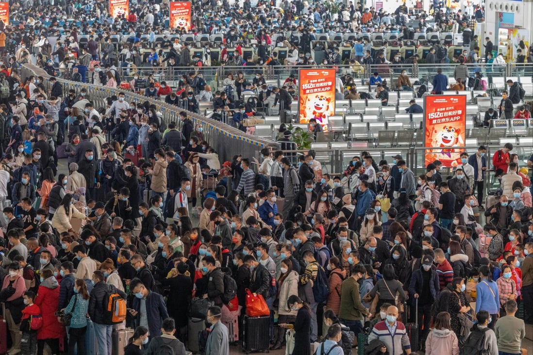 Travellers wait at a train station in Guangzhou, China during Lunar New Year in 2022. Photo: AP