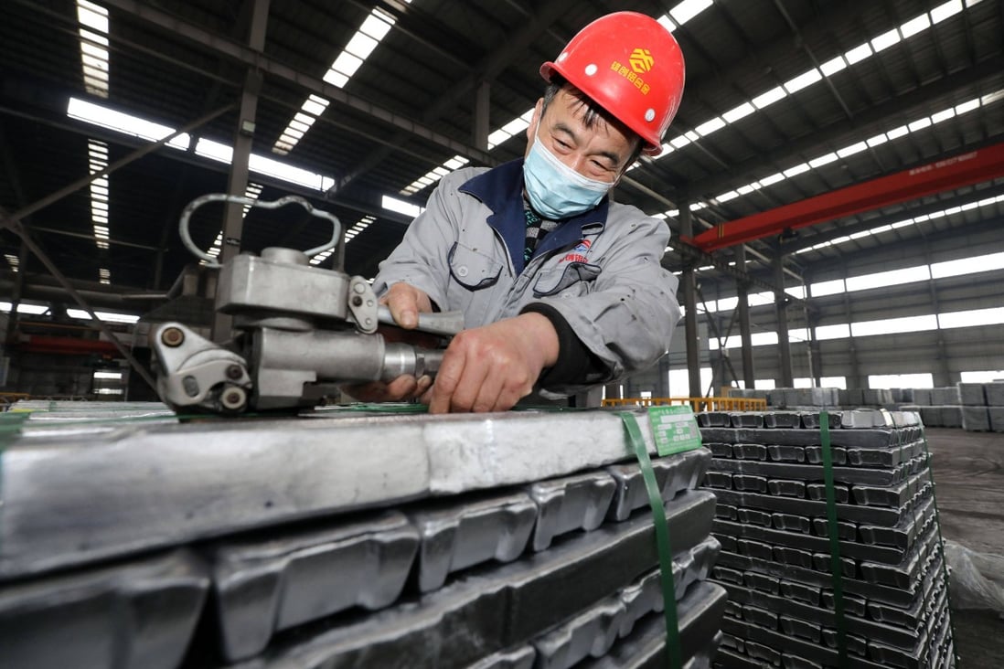 An employee works with aluminium ingots at a factory in Huaibei in China’s eastern Anhui province in February. Photo: AFP