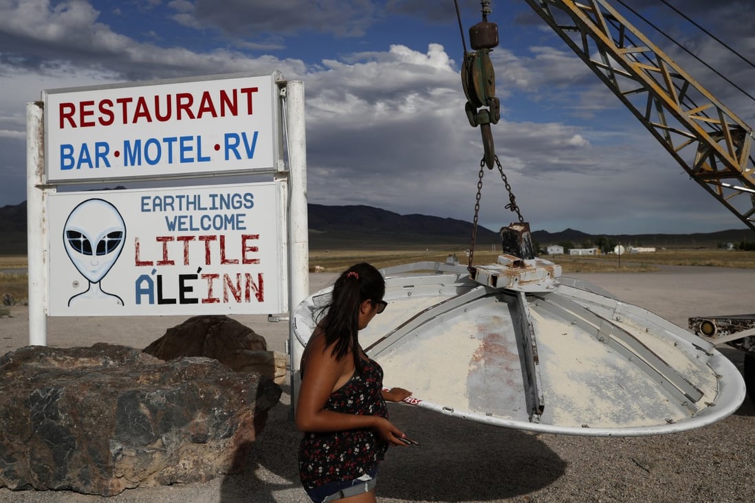 A woman looks at a UFO display outside of the Little A’Le’Inn, in Rachel, Nevada, the closest town to Area 51, in July 2019. Photo: AP