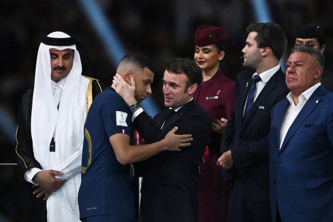 French President Emmanuel Macron with France’s Kylian Mbappe as President of the Argentine Football Association Claudio Fabian Tapia and the Emir of Qatar Sheikh Tamim bin Hamad Al Thani look on during the trophy ceremony. Photo: Reuters