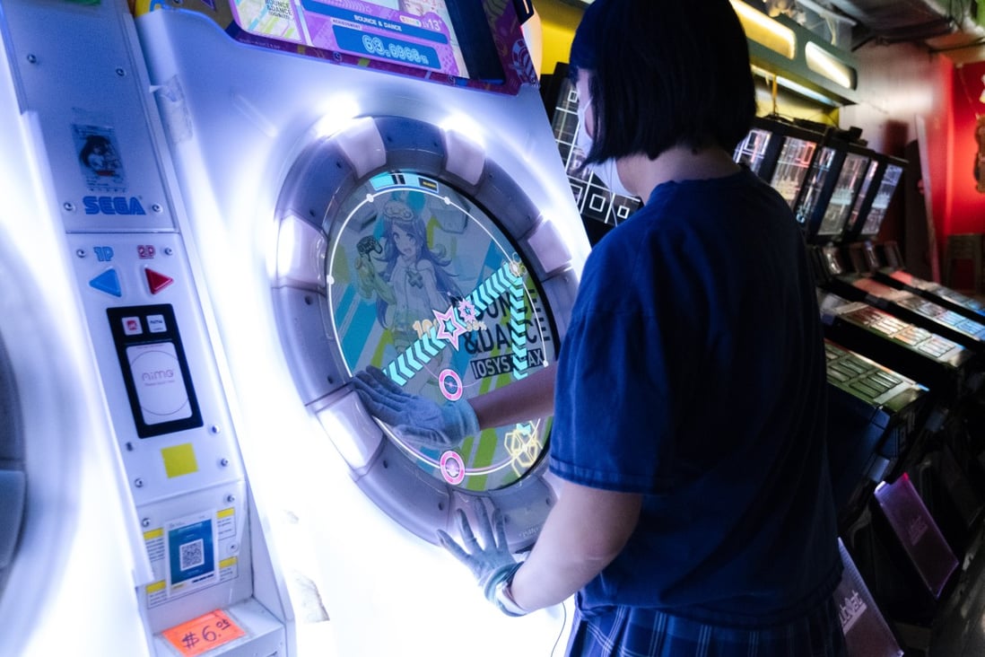 Lu Ziyang playing “Maimai DX Universe Plus” in Central, Hong Kong. A student in California, she chose an exchange programme at the University of Hong Kong so she could play the Japanese game, which isn’t officially available in the United States. Photo: Connor Mycroft