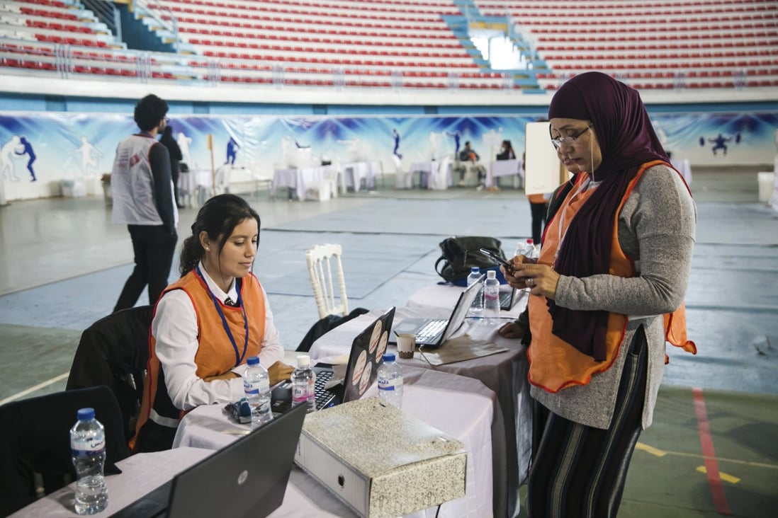 Members of the independent higher authority for elections count votes one day after the parliamentary elections in Tunis, Tunisia on Sunday. Photo: AP