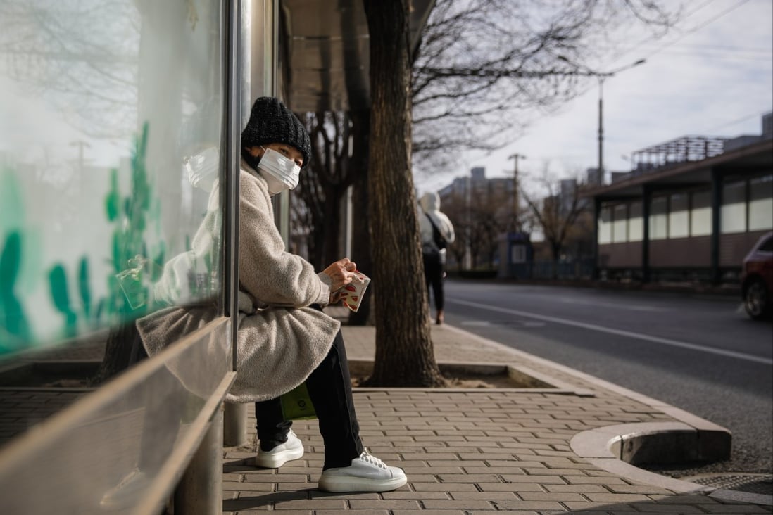 A woman sits at a bus station in Beijing on December 15. China’s growth prospects are dim not because of its changing demographics, but because its investment-led growth model has run out of steam. Photo: EPA-EFE