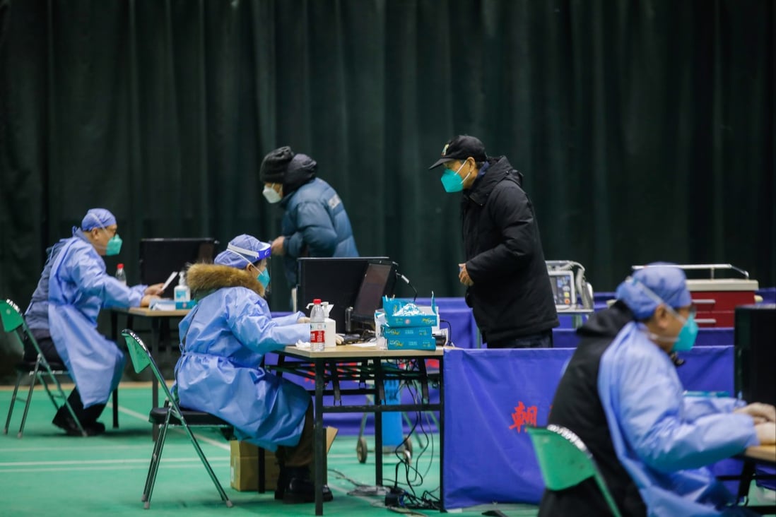 Doctors prescribe medicines for Covid-19 patients at a makeshift fever clinic in Beijing, where restrictions are easing while infections rise. Photo: EPA-EFE