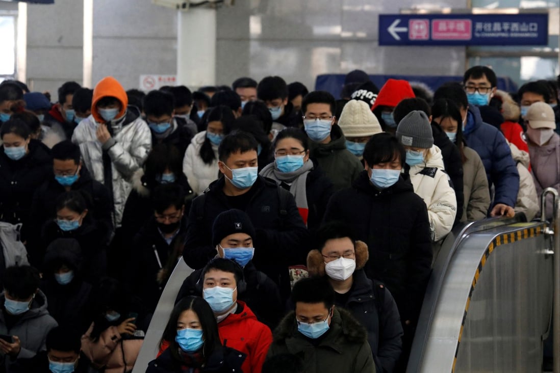 People wearing face masks enter a subway station in Beijing. Photo: Reuters