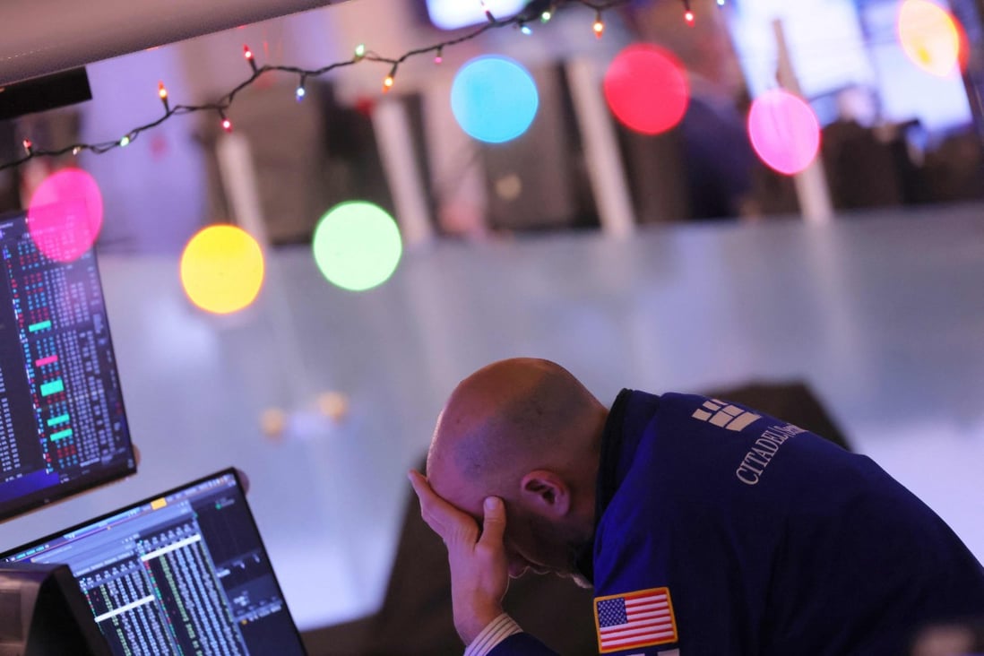 A trader work the floor at the New York Stock Exchange in New York City on December 21. Global stock and bond markets are not evolving to keep up with the demands of the modern era, funnelling savings into wealth accumulation rather than human and planetary welfare. Photo: Getty Images via AFP