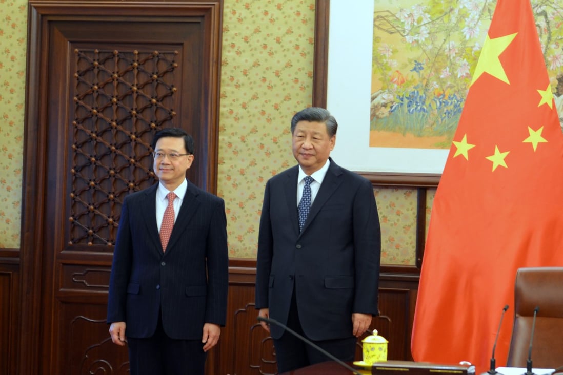 Hong Kong Chief Executive John Lee with President Xi Jinping. Photo: Pool