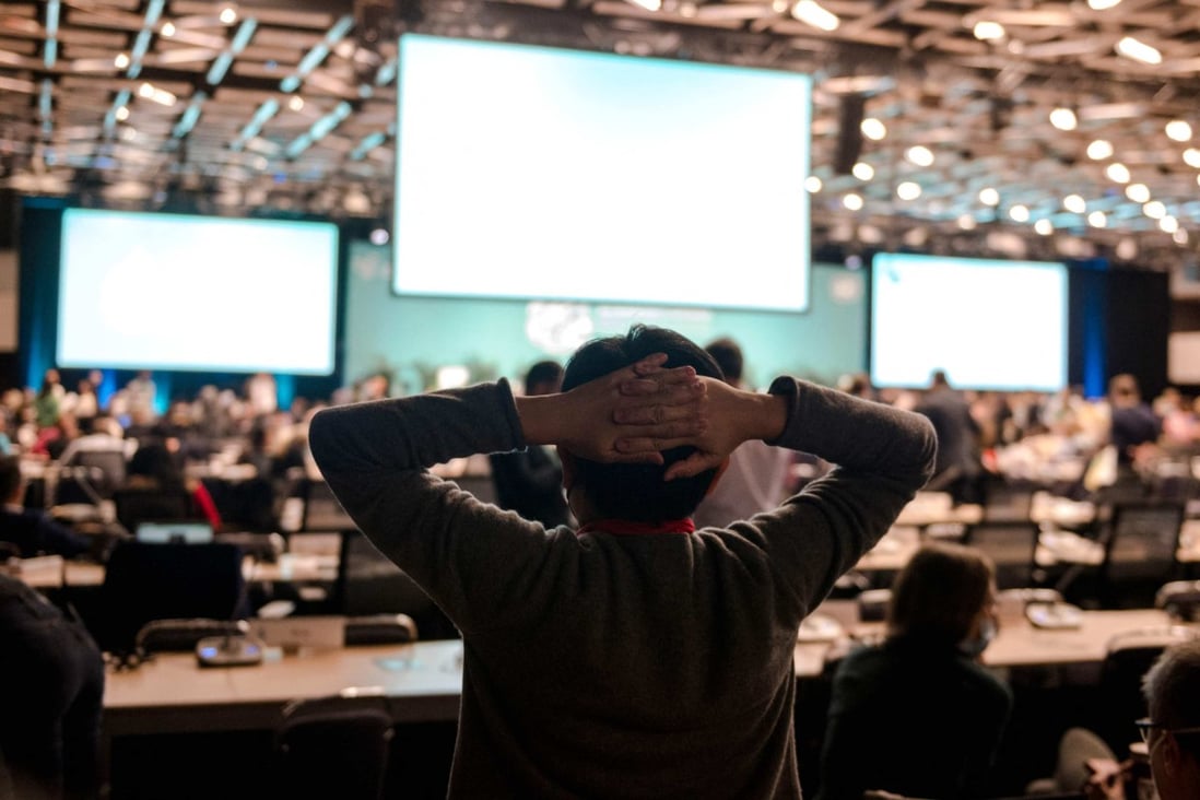 A delegate stretches before a plenary at the tail end of the United Nations Biodiversity Conference in Montreal, Quebec, Canada, on December 18. Photo: AFP