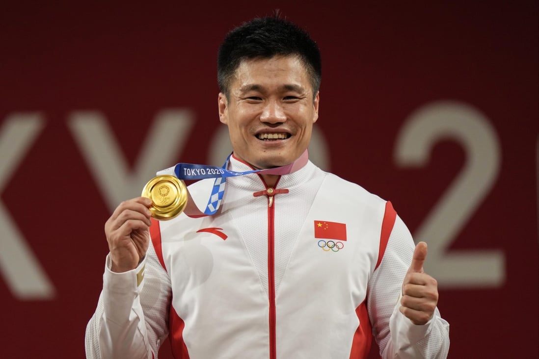 China’s Lyu Xiaojun celebrates after winning the gold medal in the men’s 81kg weightlifting event the Tokyo Olympics. Photo: AP