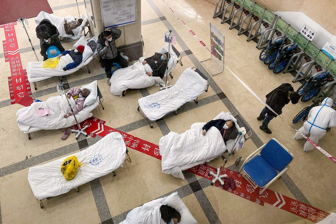 Covid-19 coronavirus patients lie on hospital beds in the foyer of the Chongqing No 5 People’s Hospital on Friday. Photo: AFP