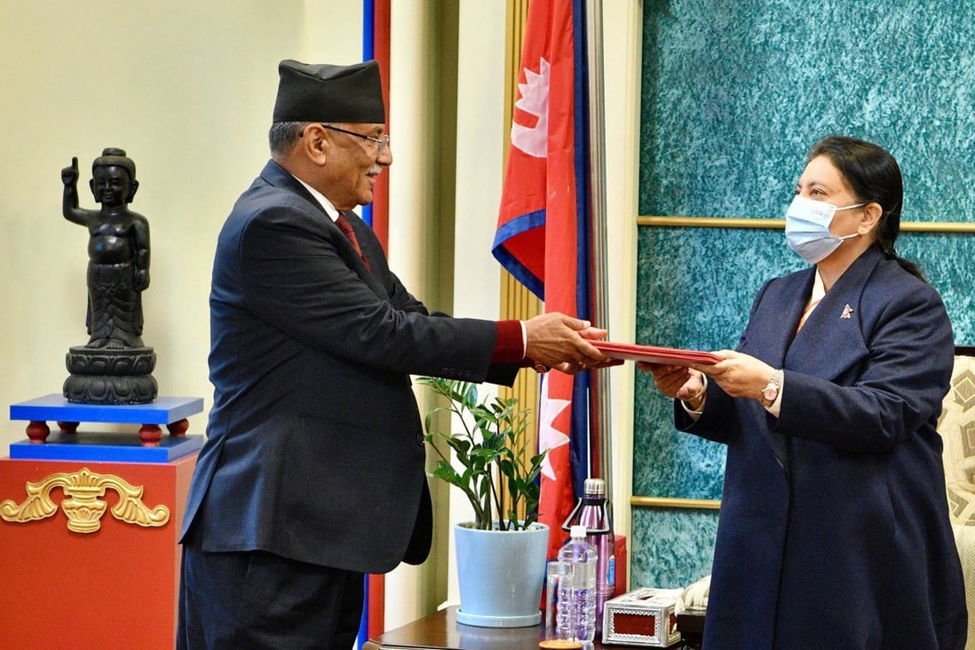 Nepal’s former guerrilla leader Pushpa Kamal Dahal (left), better known by his nom de guerre Prachanda, hands over his documents to President Bidya Devi Bhandari to claim majority for his appointment as the new prime minister, at the president’s office in Kathmandu on December 25, 2022. Photo: AFP