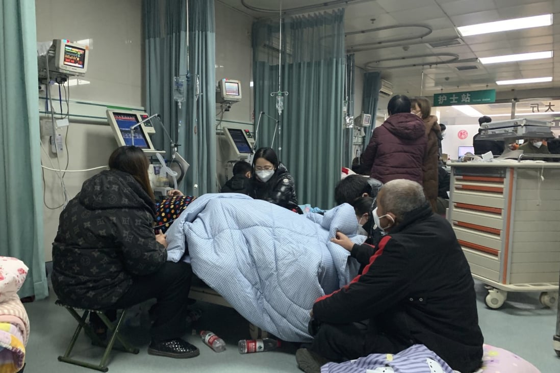 Relatives gather near the bed of a Covid-19 patient at a hospital in Bazhou city, northern China’s Hebei province, on December 22. Photo: AP