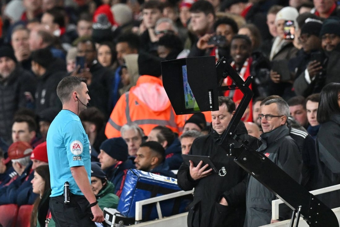 Referee Michael Olivier checks the VAR to verify a foul during the English Premier League game between Arsenal and West Ham United at the Emirates Stadium on December 26. Photo: AFP
