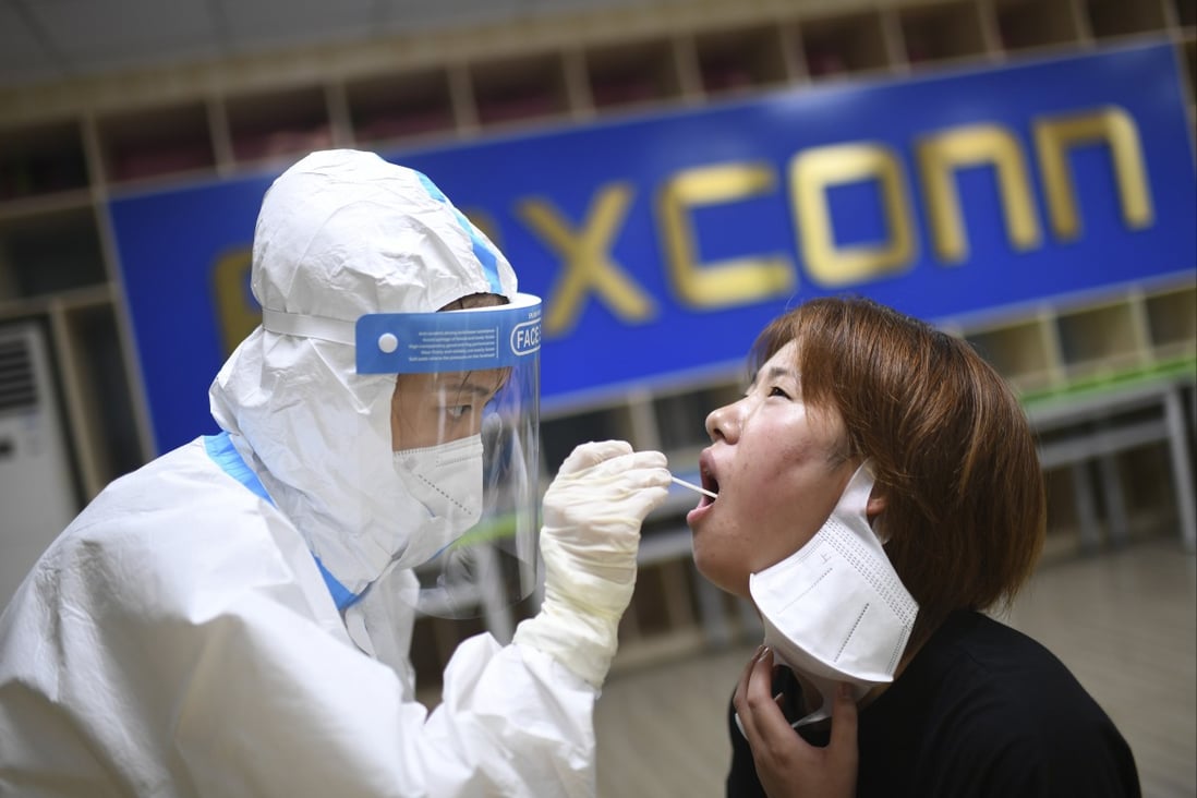 A medical worker takes a swab to test a Foxconn Technology Group employee for Covid-19 in Wuhan, capital of central Hubei province, on August 5, 2021. Photo: AP