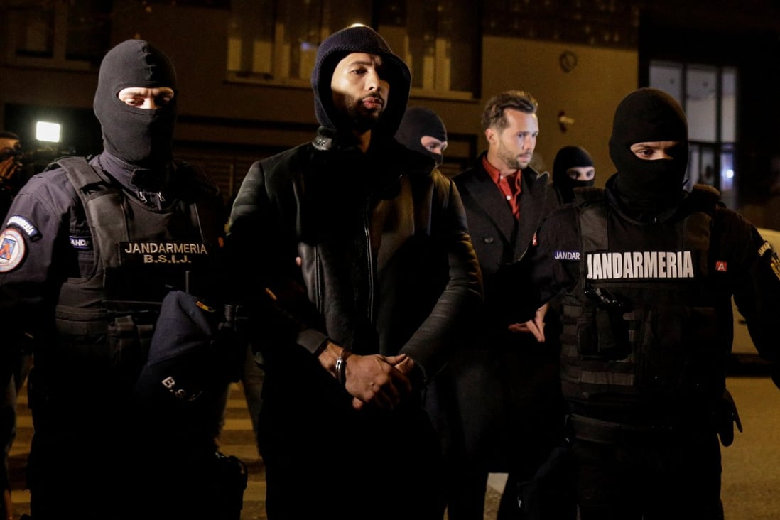 Andrew Tate and Tristan Tate being escorted by police in Bucharest, Romania. Photo: Inquam Photos/Octav Ganea via Reuters