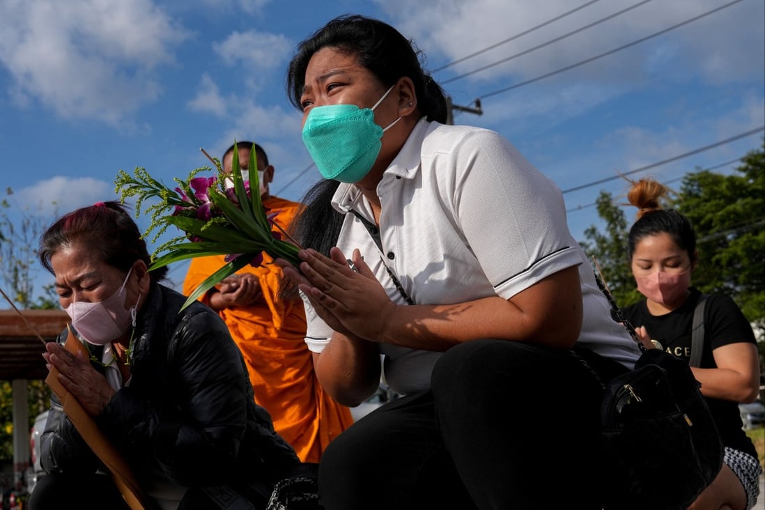 Nunthida Kongreung, whose parents died in the Grand Diamond hotel-casino fire, prays with other family members in Sa Kaeo province near the Thailand-Cambodia border on Friday. Photo: Reuters