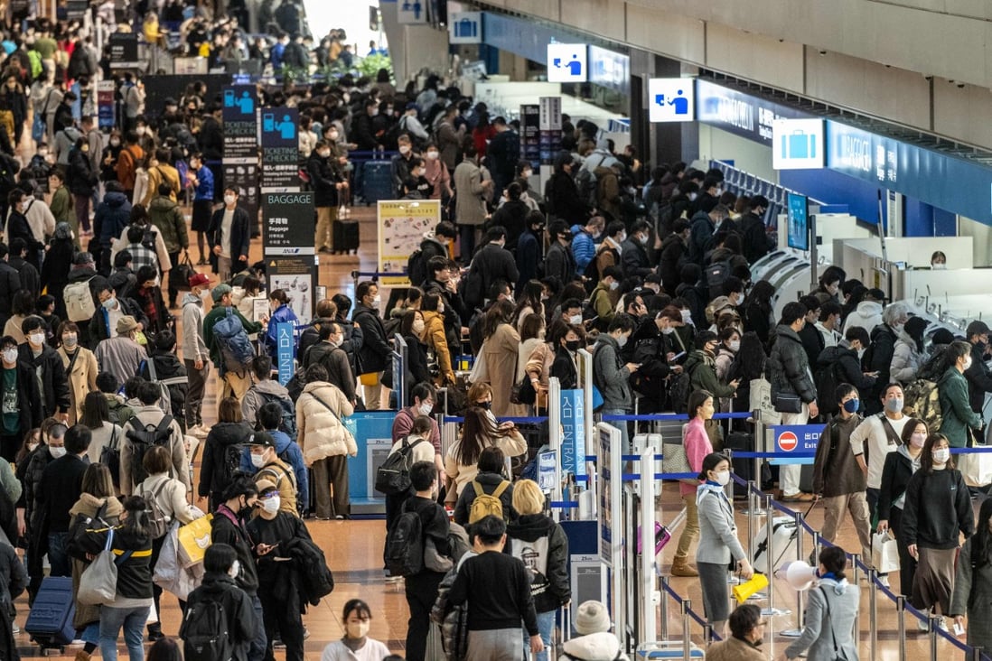 ‘Simply a gesture’: tour agents question Japan’s policy for Hong Kong arrivals 5 Travellers at Tokyo’s Haneda airport. Photo: AFP