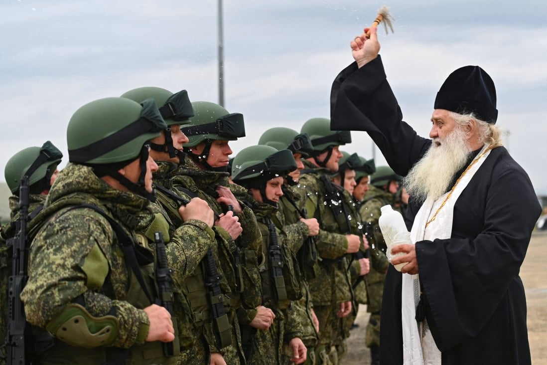 A priest sprinkles holy water on Russian reservists recruited during the partial mobilisation of troops before their departure to the Russia-Ukraine conflict. Dozens, even hundreds, are said to have been killed in a strike in the Donetsk region. File photo: Reuters