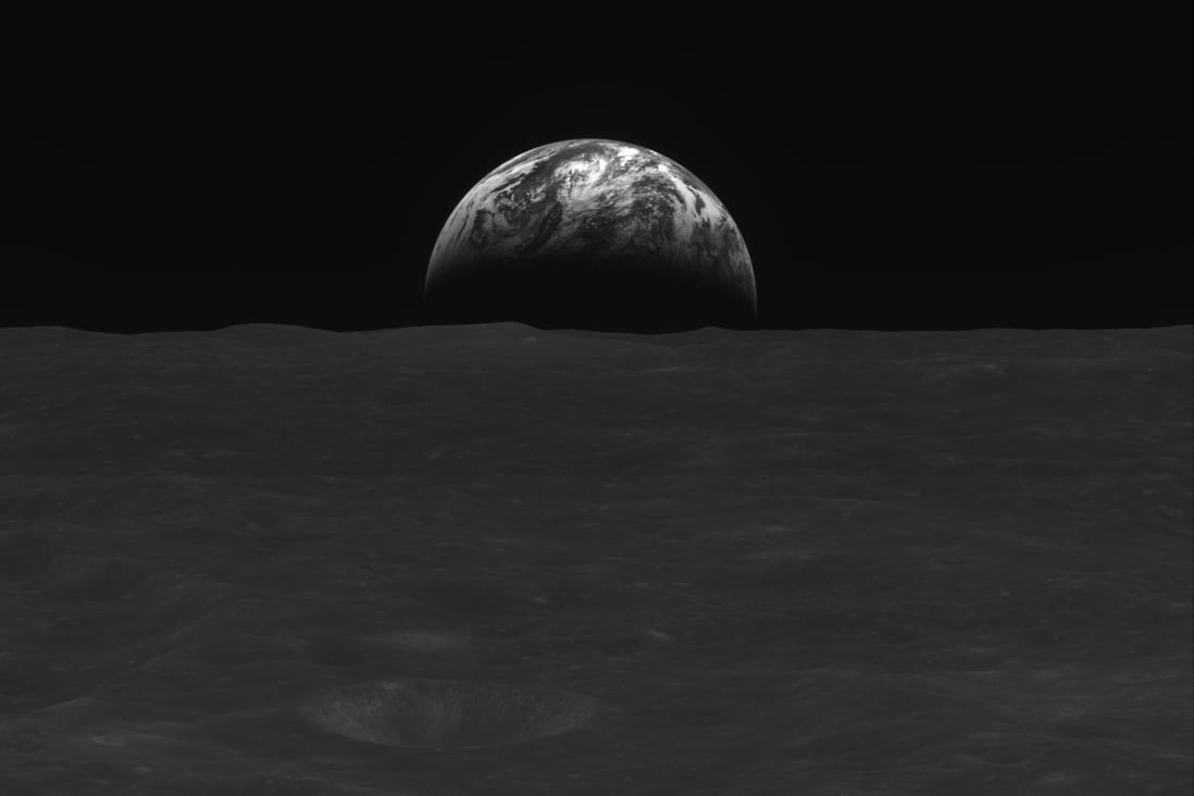 A black-and-white image of the Moon’s surface and Earth taken by South Korean lunar orbiter Danuri. Photo: Handout via AFP