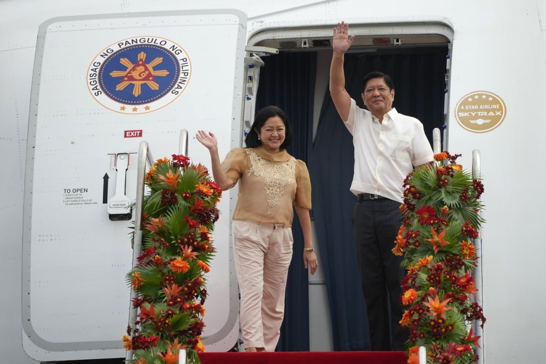 Philippine President Ferdinand Marcos Jnr (right) and his wife Marie Louise wave as they board a plane for China on Tuesday at the Villamor Air Base in Manila. Photo: AP