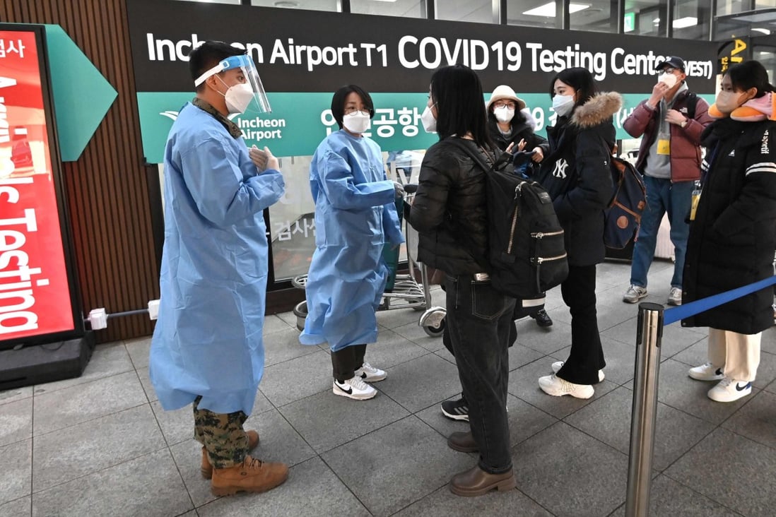 Health workers direct travellers arriving from China to a Covid-19 testing centre at Incheon International Airport in South Korea on Tuesday. Photo: AFP