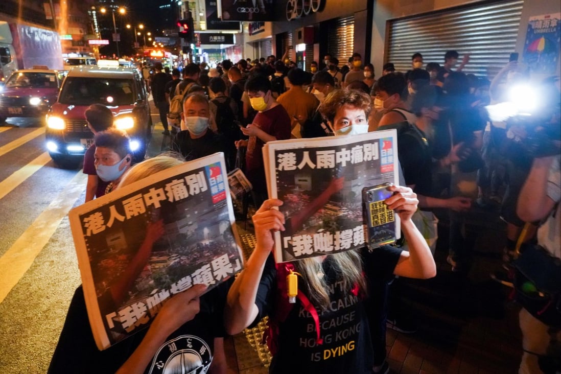 People queueing for the last edition of Apple Daily in Mong Kok at midnight on June 24, 2021. Photo: Felix Wong