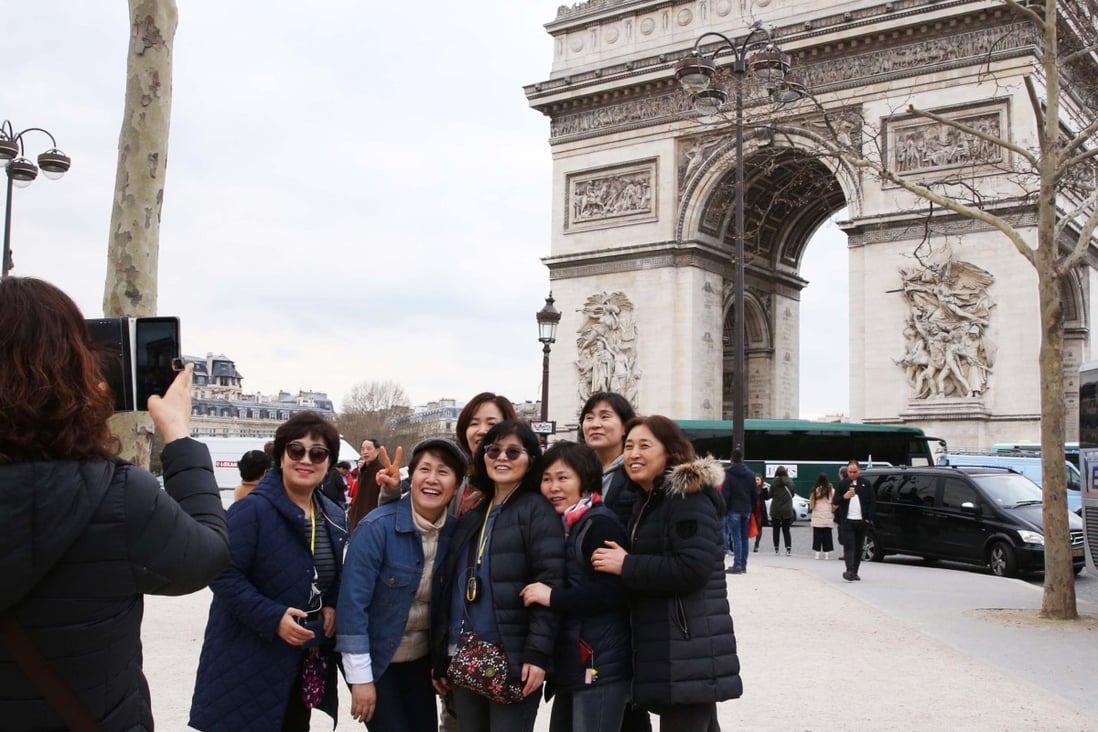 Chinese tourists in Paris. Exports do not expect them to return to luxury shopping hubs such as the French capital any time soon – high-end spenders have got used to buying at home. Photo: Xinhua