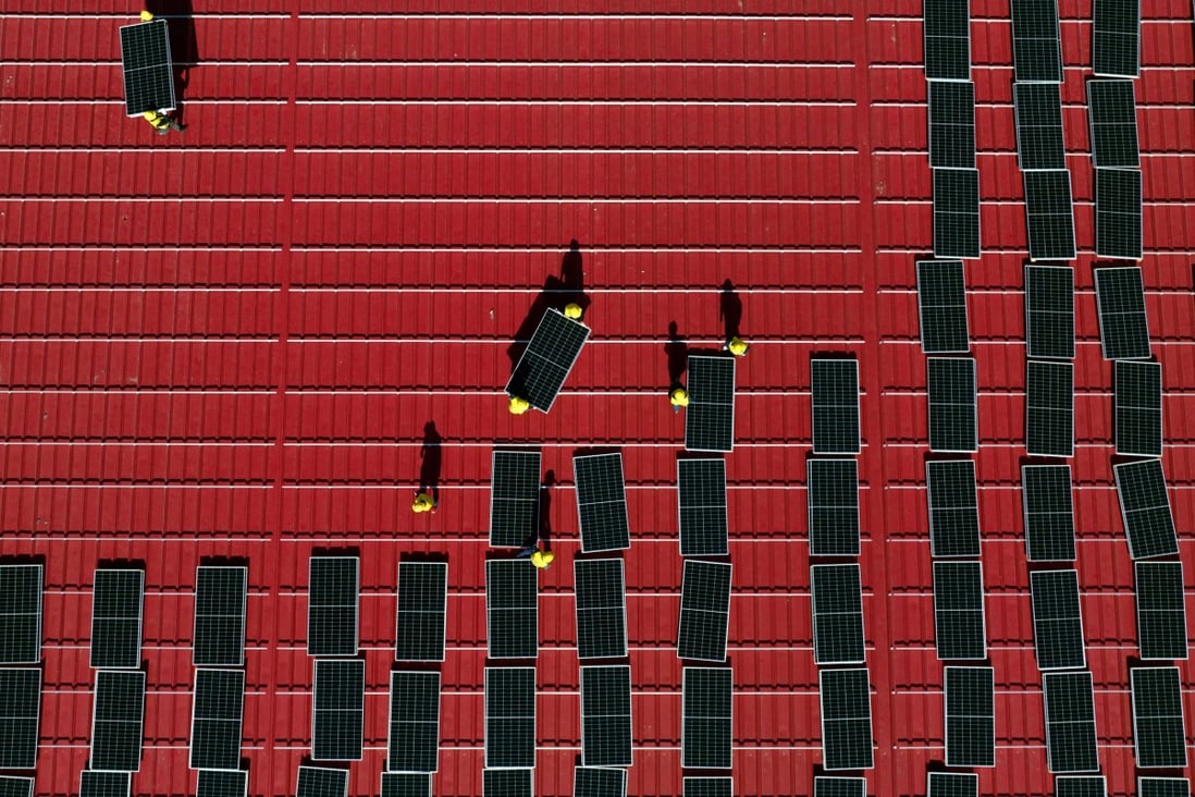 Workers install solar power panels on the roof of a factory in Tangshan, north China’s Hebei province. Chinese firms are seen benefiting from a financing pact for Vietnam. Photo: Xinhua