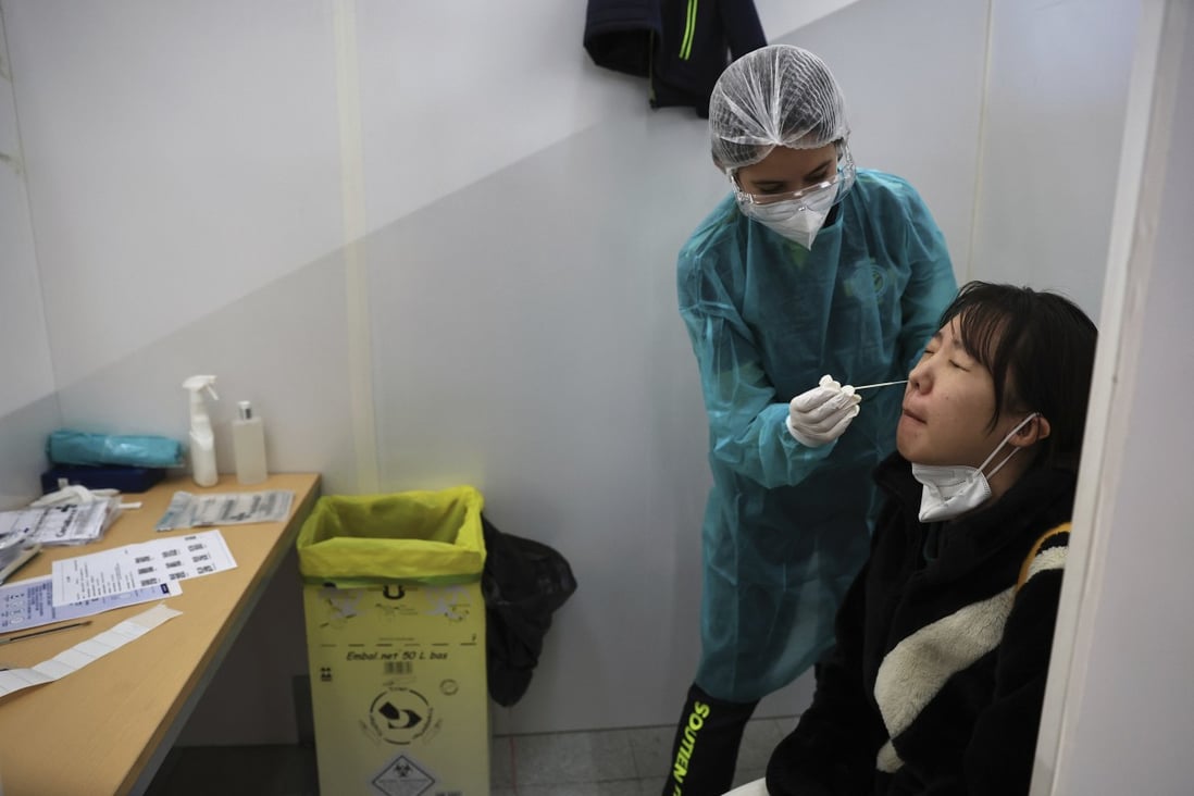 A passenger arriving from China is tested for Covid-19 at the airport in Paris. Photo: AP