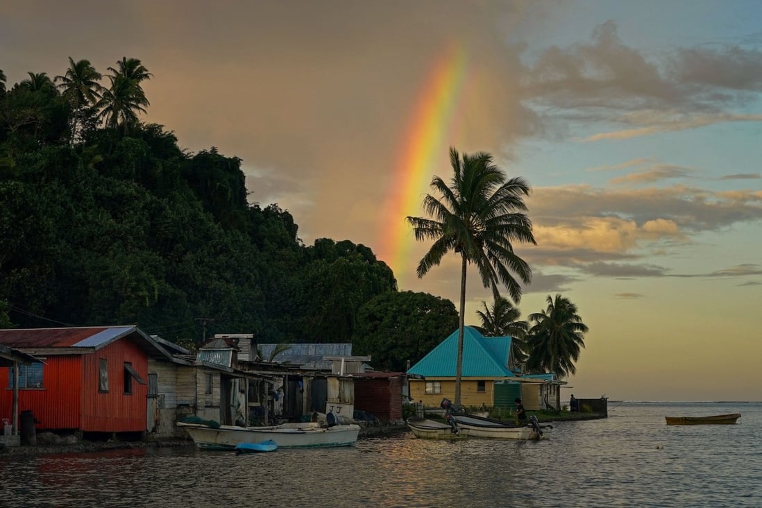 A rainbow forms over Serua Village, Fiji, where villagers face the painful decision whether to move. Photo: Reuters